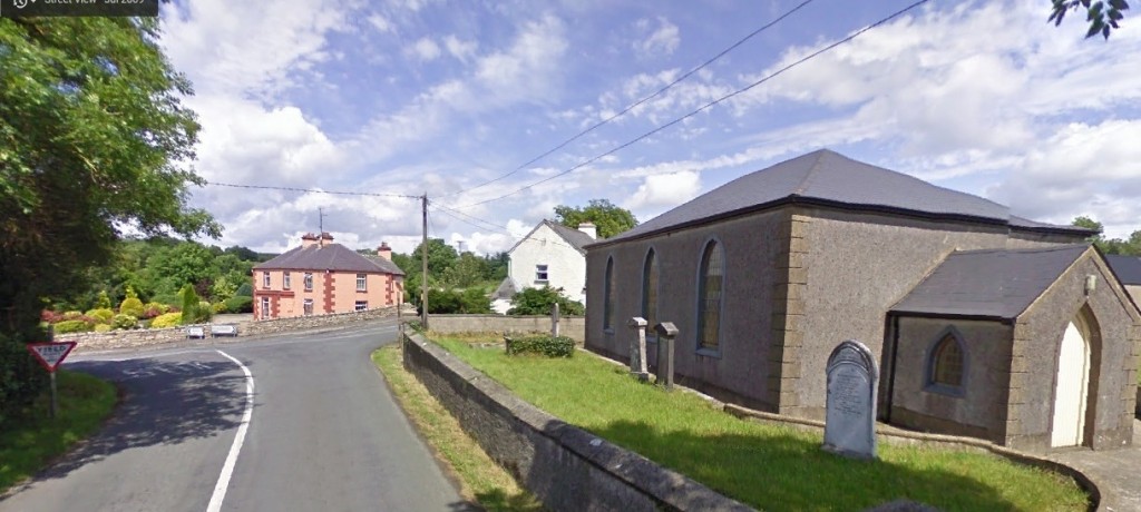 'Kivvy Cross' in Carrigallen, overlooked by Carrigallen Presbyterian Church built in 1836
